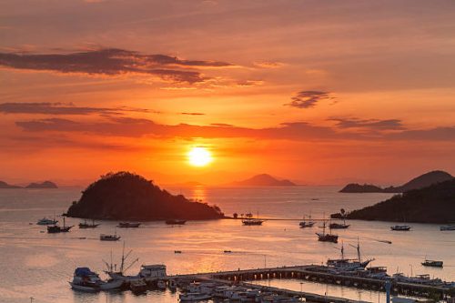Dramatic sunset over the harbor of Labuan Bajo, in Flores island of Indonesia; famous place to access the Komodo National Park.